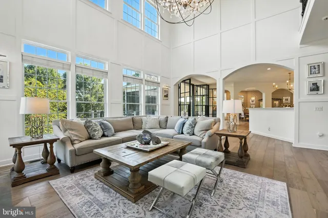 a living room with furniture a fireplace and a floor to ceiling window