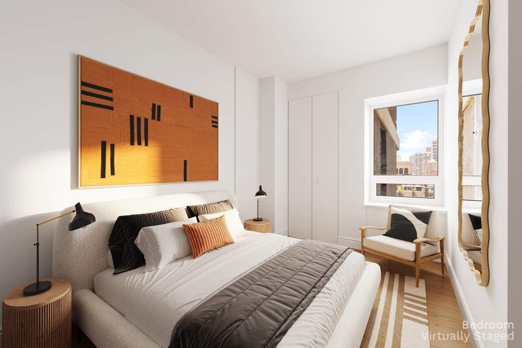 425 East 58th Street, Unit 20E Manhattan, NY 10022 - Photo 14 of 19 a bedroom with a bed and wooden floor