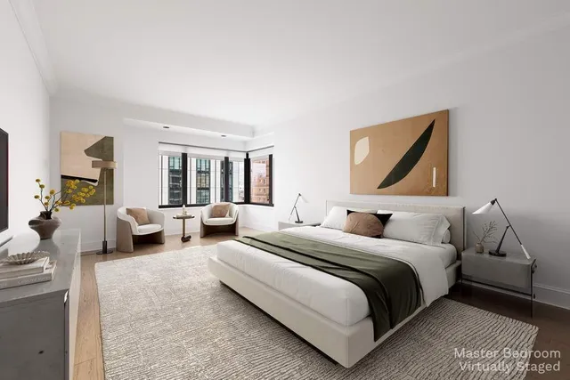 a bedroom with bed couch and window