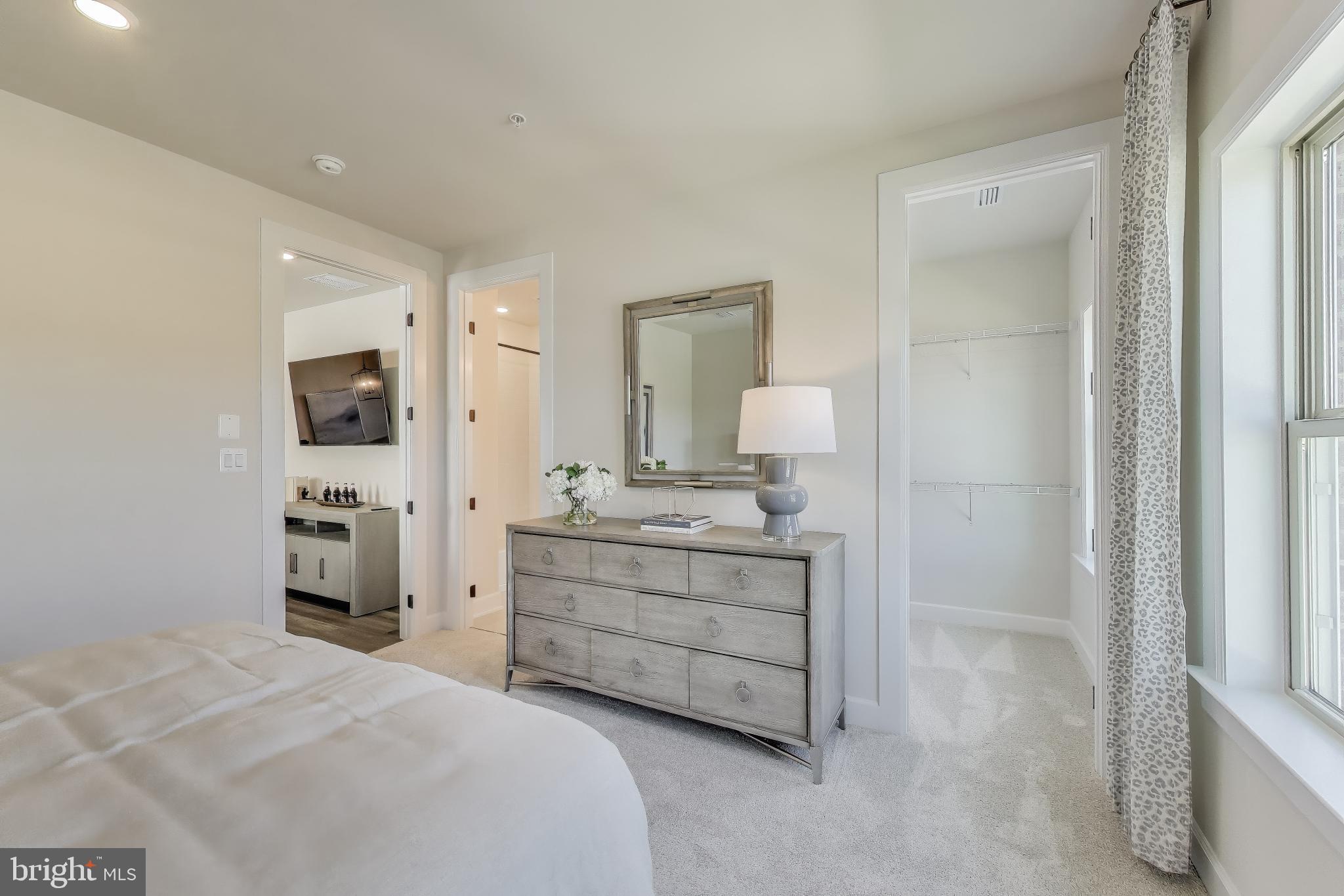 1303 Clubhouse Boulevard Laurel, MD 20708 - Photo 16 of 18 a room with a bed and a mirror