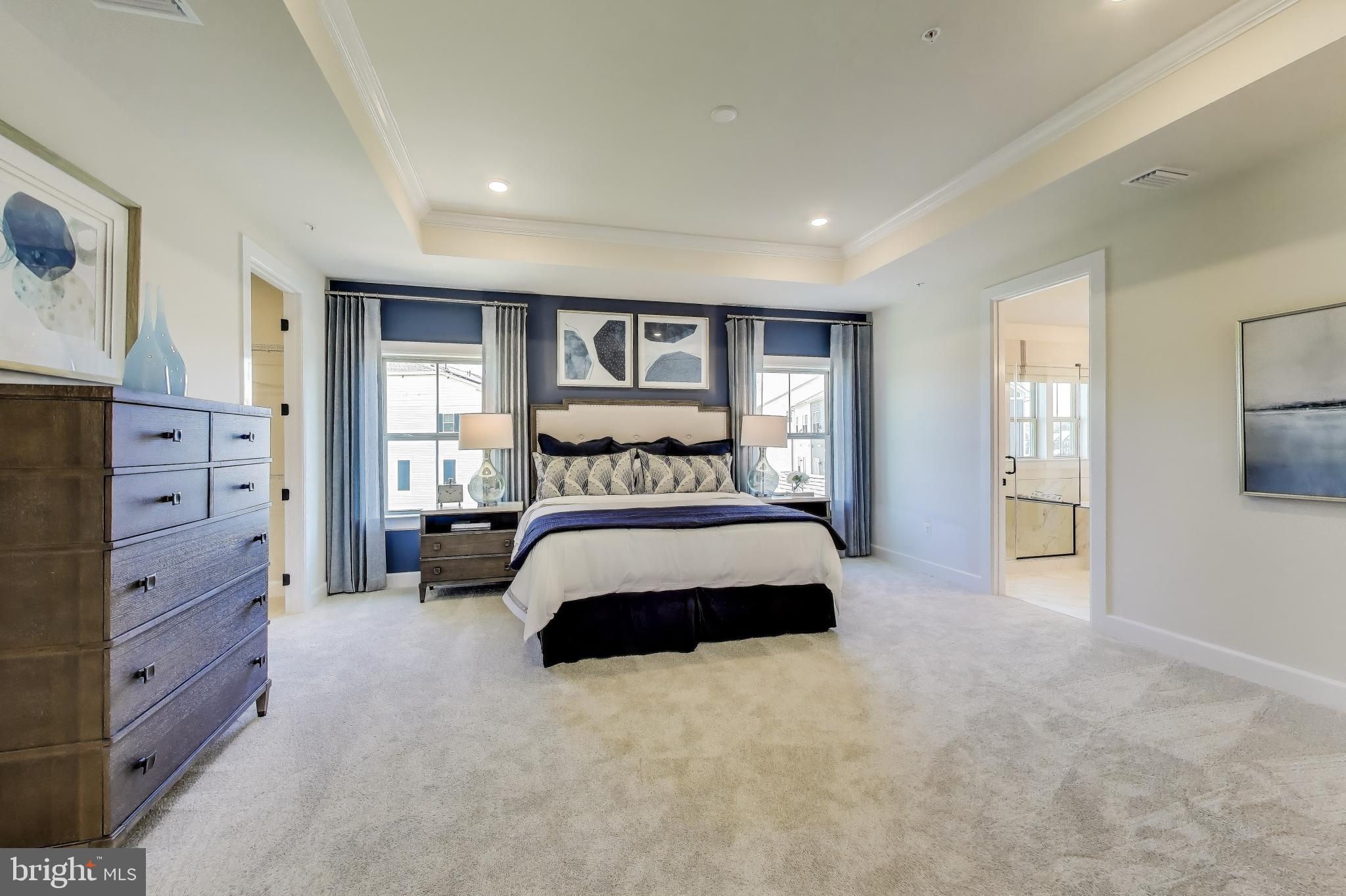 1303 Clubhouse Boulevard Laurel, MD 20708 - Photo 3 of 18 a bedroom with a large bed and a tv