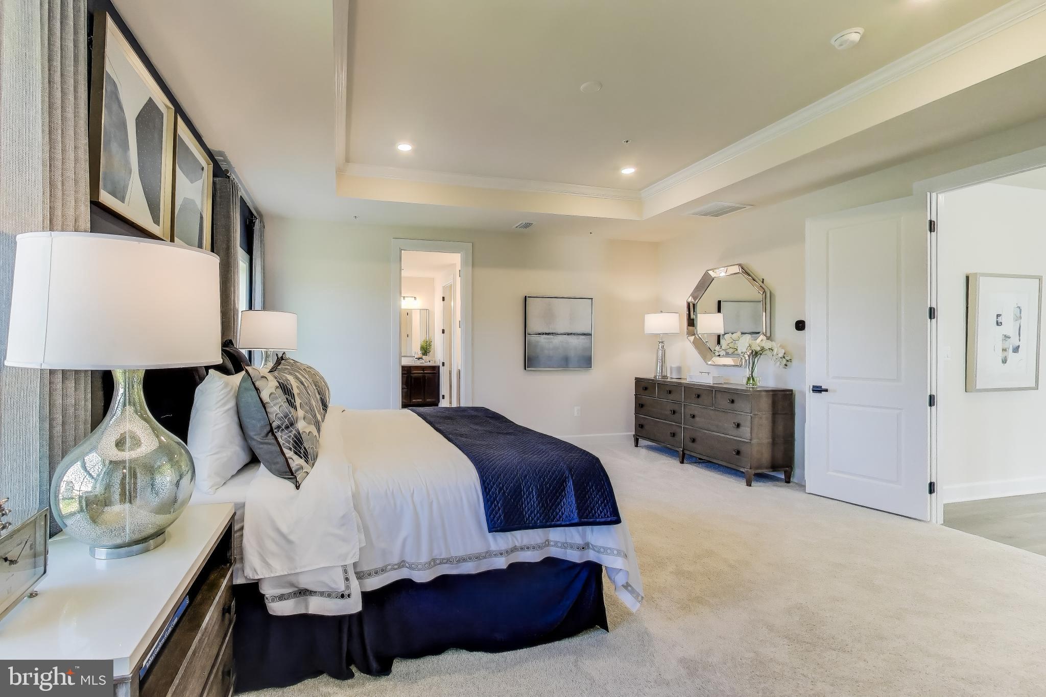 1303 Clubhouse Boulevard Laurel, MD 20708 - Photo 4 of 18 a spacious bedroom with a bed a window and dresser