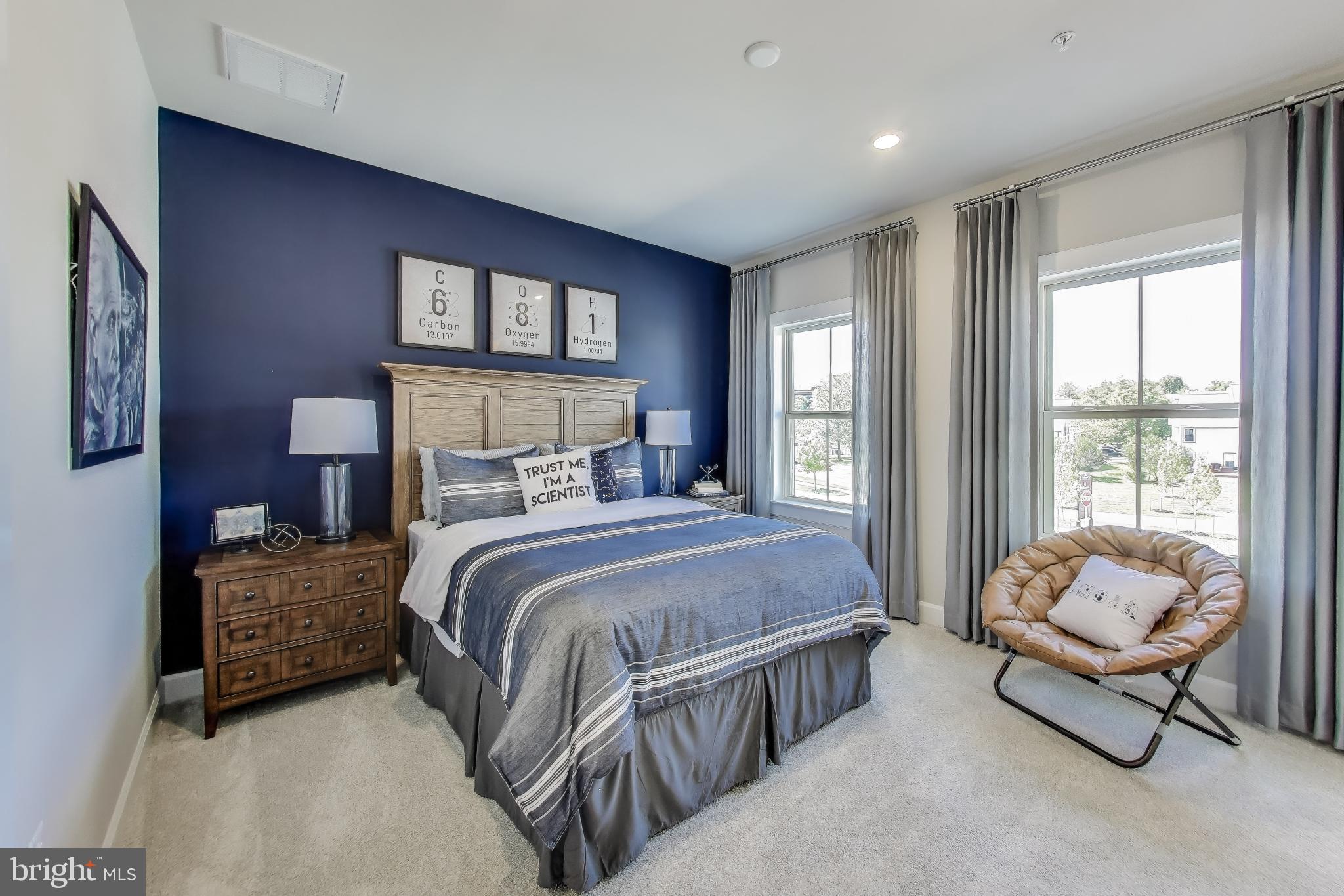 1303 Clubhouse Boulevard Laurel, MD 20708 - Photo 5 of 18 a spacious bedroom with a bed a table and windows