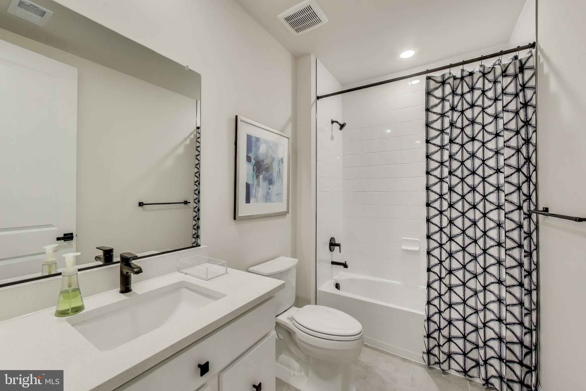 1303 Clubhouse Boulevard Laurel, MD 20708 - Photo 6 of 18 a bathroom with a sink toilet and shower
