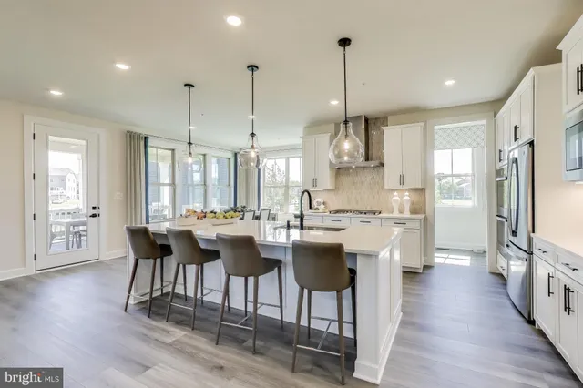 a view of a kitchen with kitchen island granite countertop a table and chairs
