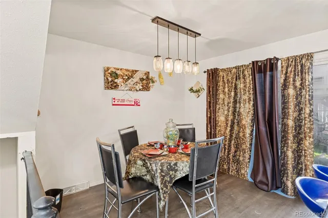 a view of a dining room with furniture and a window