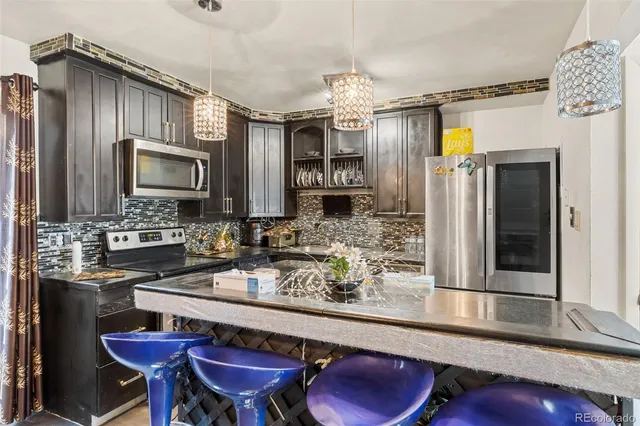 a kitchen with a refrigerator and a sink