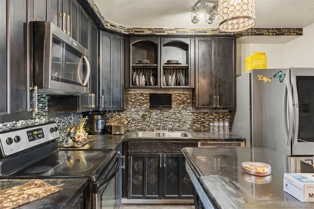 a kitchen with stainless steel appliances granite countertop a stove and a refrigerator