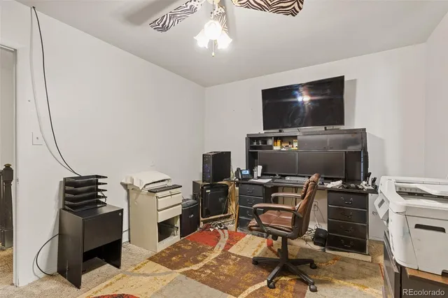 a view of a workspace with furniture and a fireplace