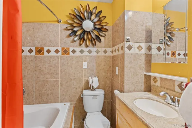 a bathroom with a sink a toilet and shower curtain