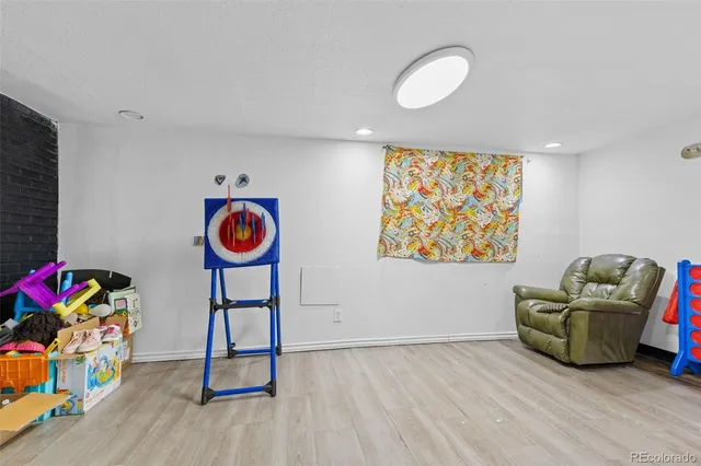 a view of a room with toys and wooden floor