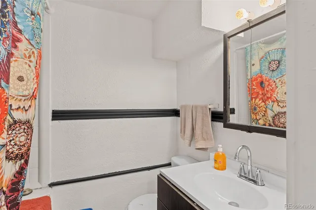 a bathroom with a sink and a shower curtain