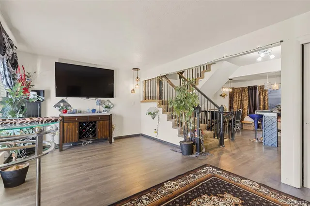 a view of an livingroom with furniture and a flat screen tv