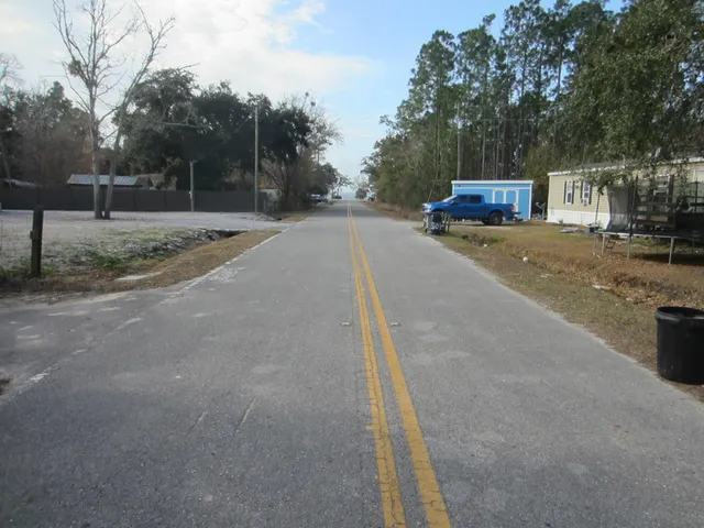 a view of street with parked cars