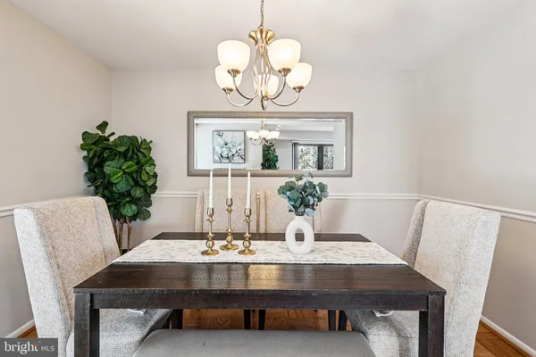 a view of a dining room with furniture and chandelier