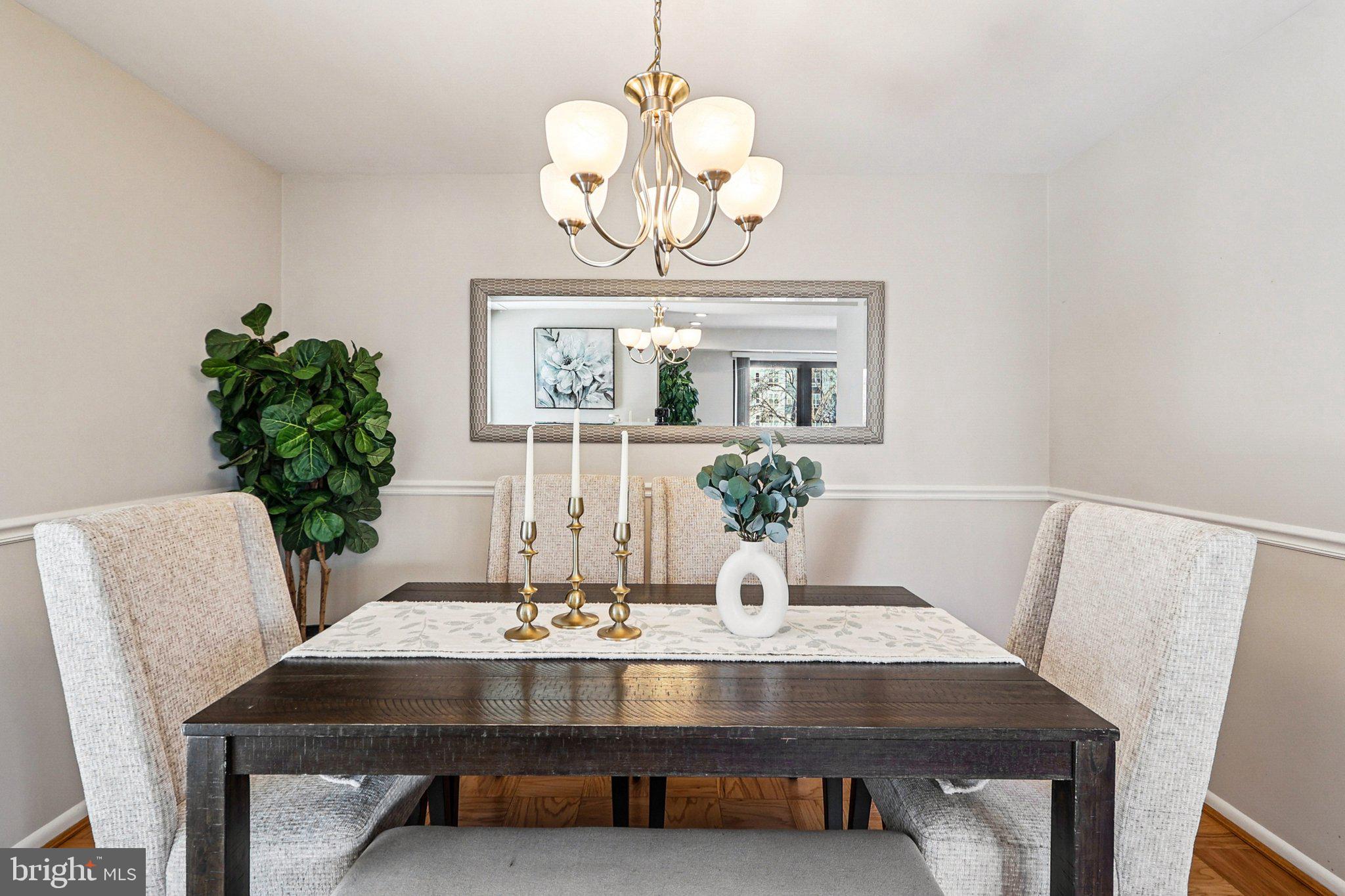9900 Georgia Avenue, Unit 27217 Silver Spring, MD 20902 - Photo 11 of 50 a view of a dining room with furniture and chandelier