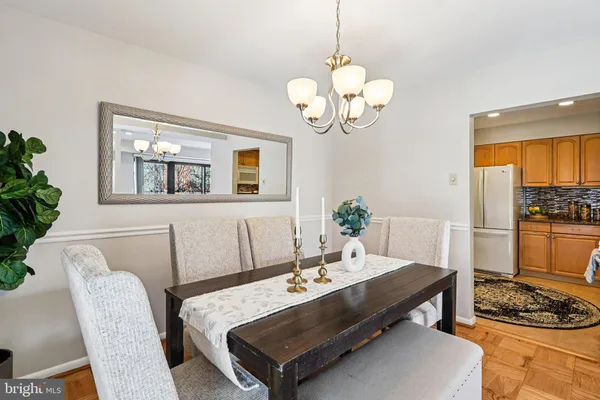 a living room with dining table and chairs