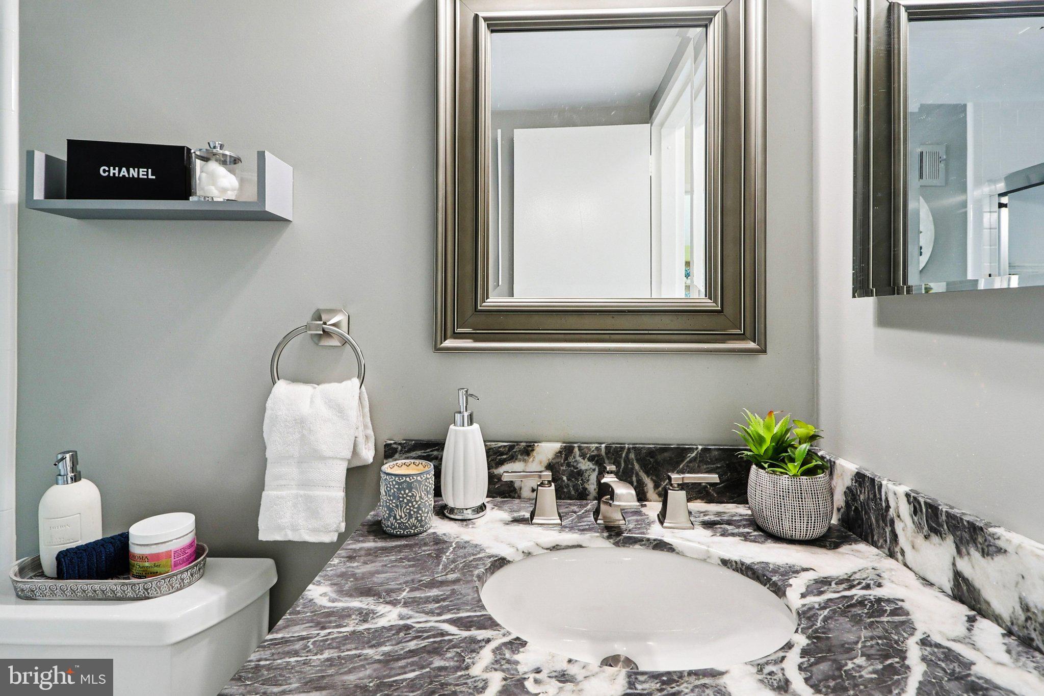 9900 Georgia Avenue, Unit 27217 Silver Spring, MD 20902 - Photo 28 of 50 a bathroom with a sink and a mirror