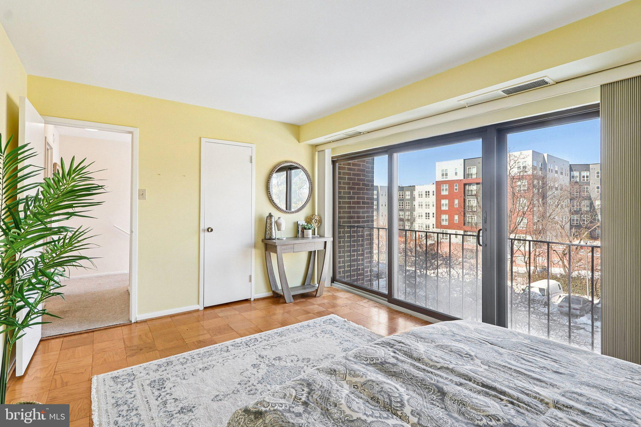 9900 Georgia Avenue, Unit 27217 Silver Spring, MD 20902 - Photo 31 of 50 a bedroom with a bed and a large window