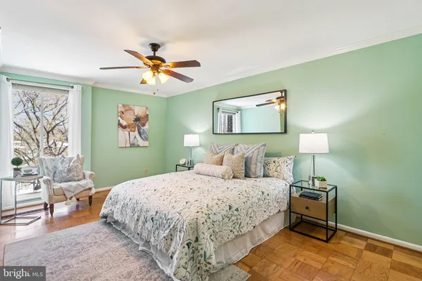 a bedroom with a large bed and a chandelier