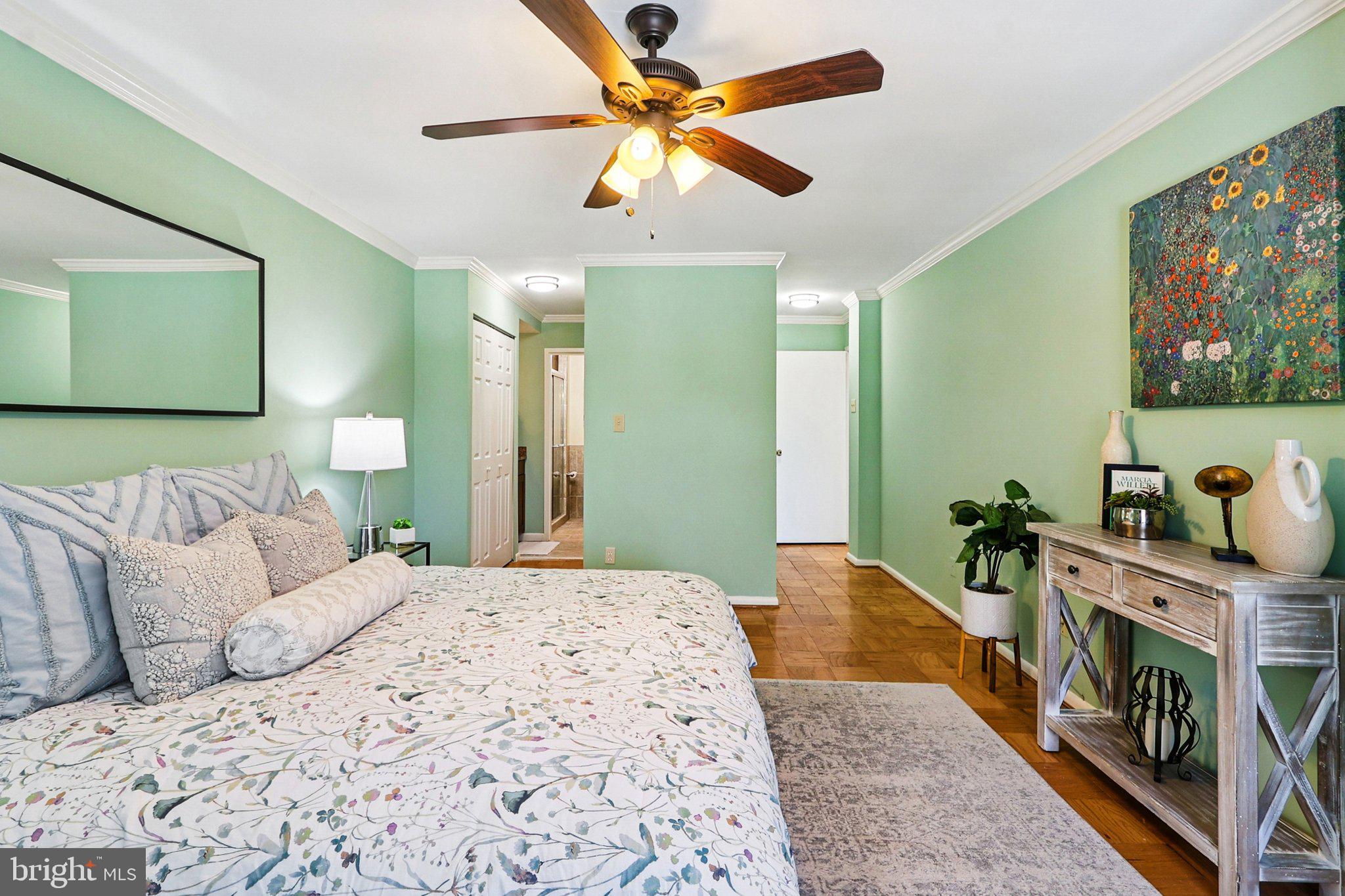 9900 Georgia Avenue, Unit 27217 Silver Spring, MD 20902 - Photo 35 of 50 a bedroom with a bed and a chandelier