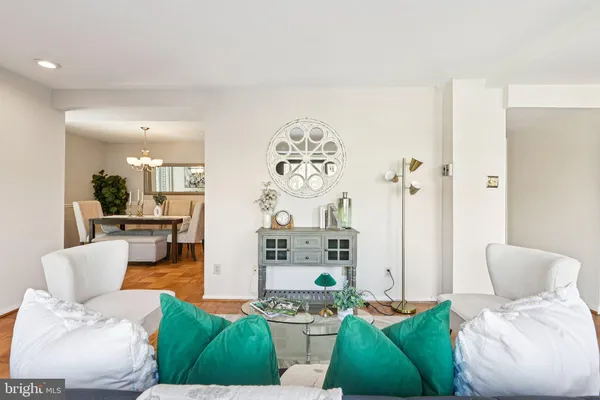 a living room with furniture and a large mirror