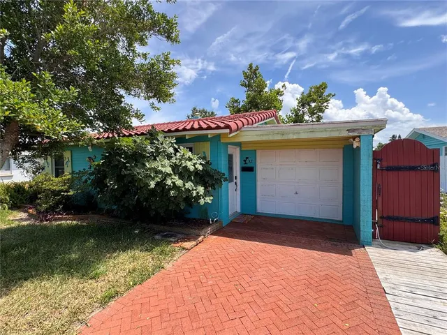 a front view of a house with a yard garage and outdoor seating