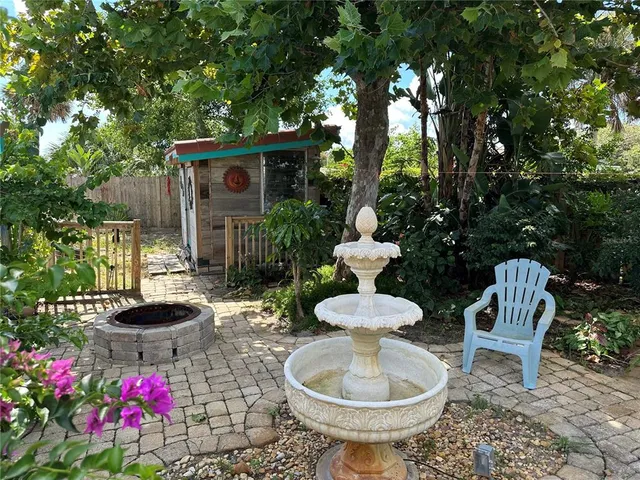 a view of a chairs and table in backyard