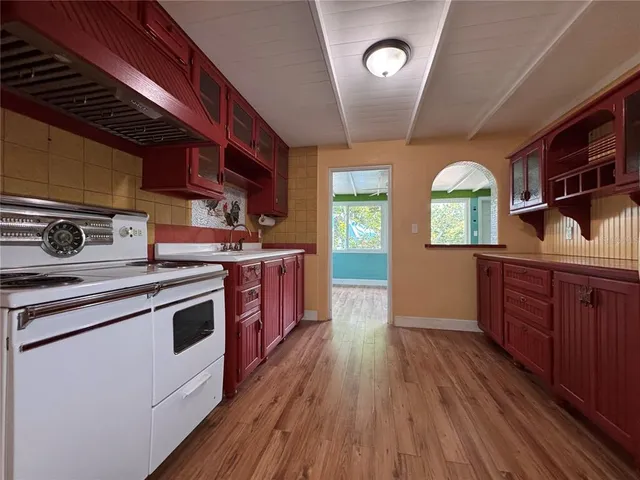 a kitchen with stainless steel appliances granite countertop wooden floors and sink
