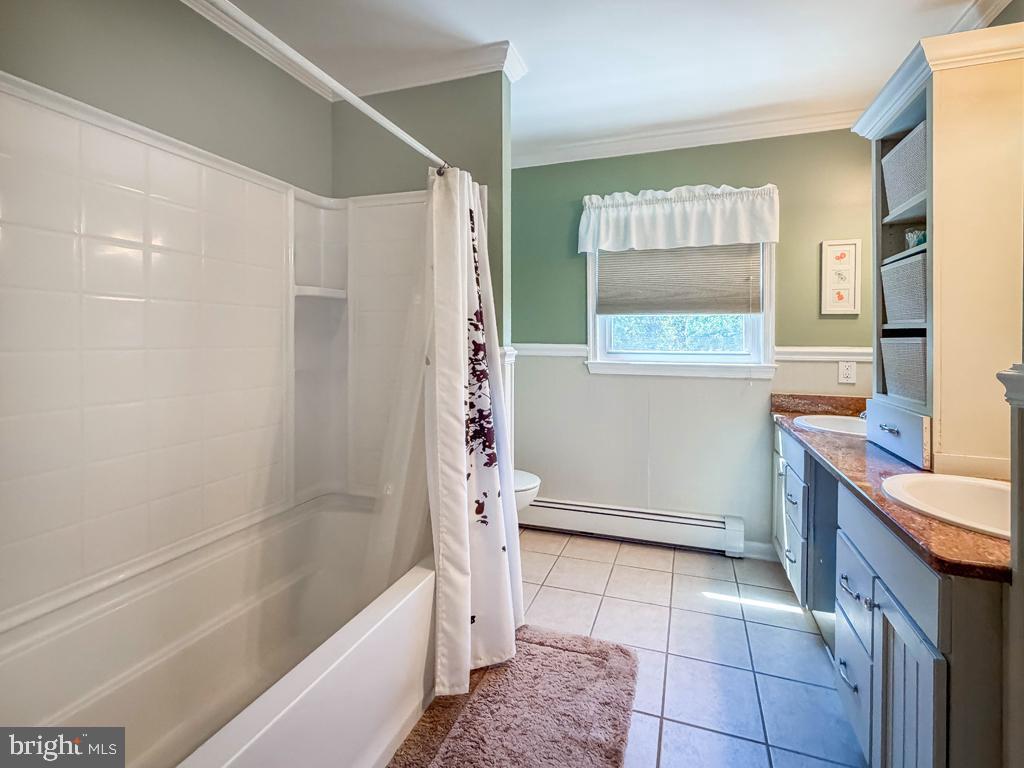 925 Big Oak Road Yardley, PA 19067 - Photo 42 of 51 a bathroom with a granite countertop sink a mirror and a bathtub