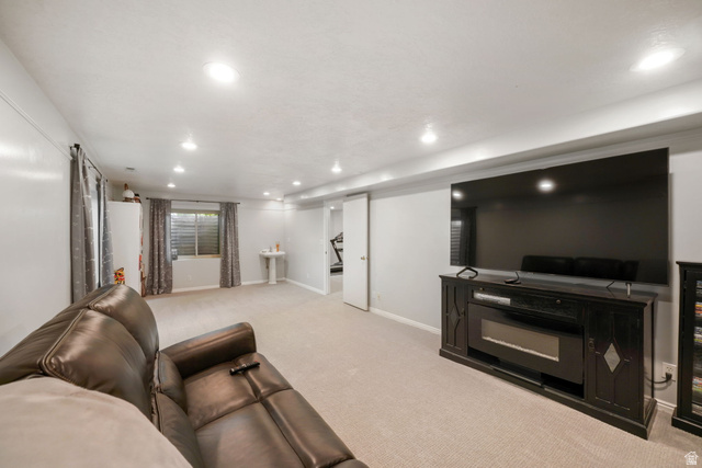 357 South 320 W Street Lindon, UT 84042 - Photo 23 of 41 Spacious room featuring recessed lighting, light-toned carpet flooring, a built-in entertainment console with an electric fireplace, and a window with blinds