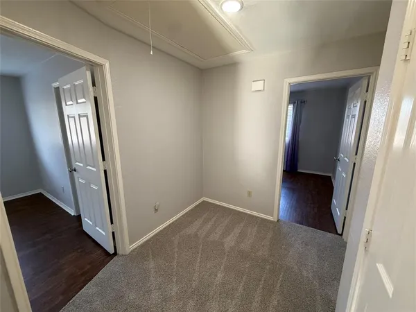 an entryway with a window and wooden floor