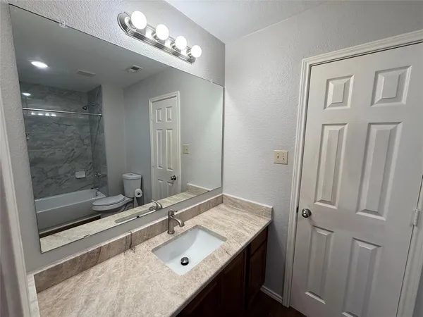 a bathroom with a sink double vanity and a mirror