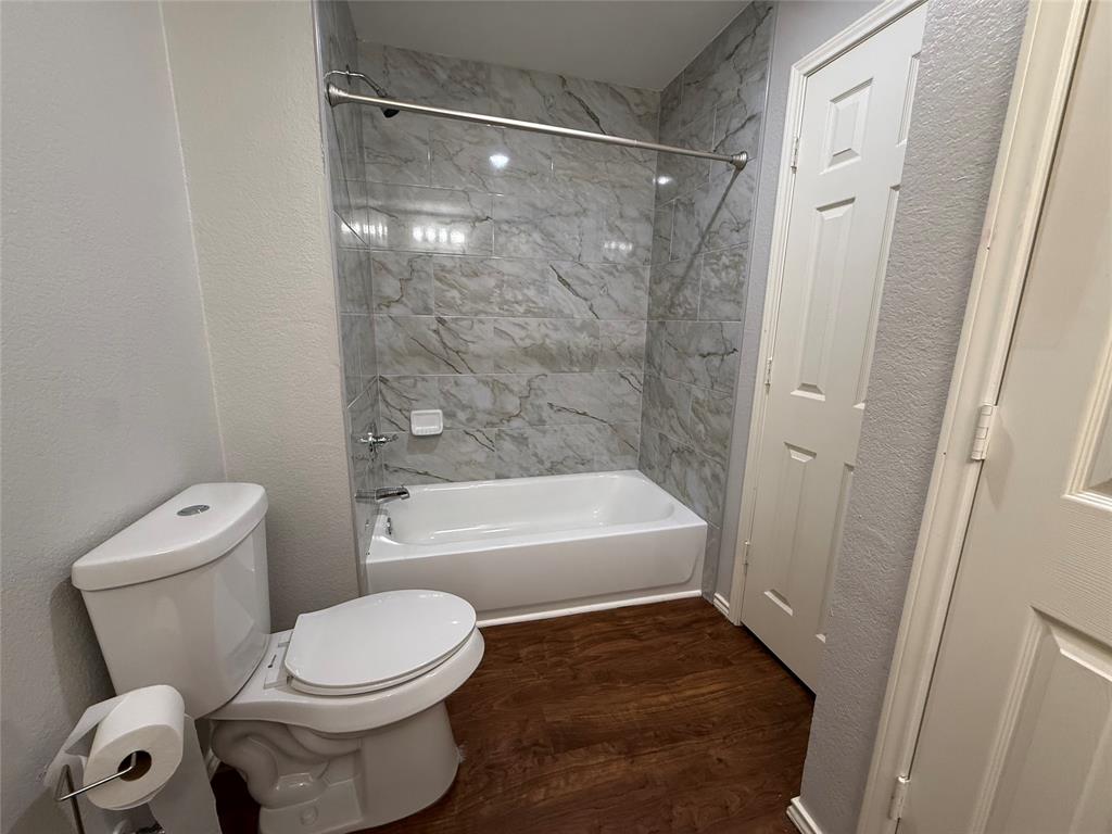 7913 Rice Drive Rowlett, TX 75088 - Photo 19 of 20 a bathroom with a toilet and a bath tub