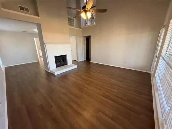 wooden floor in an empty room with a fireplace