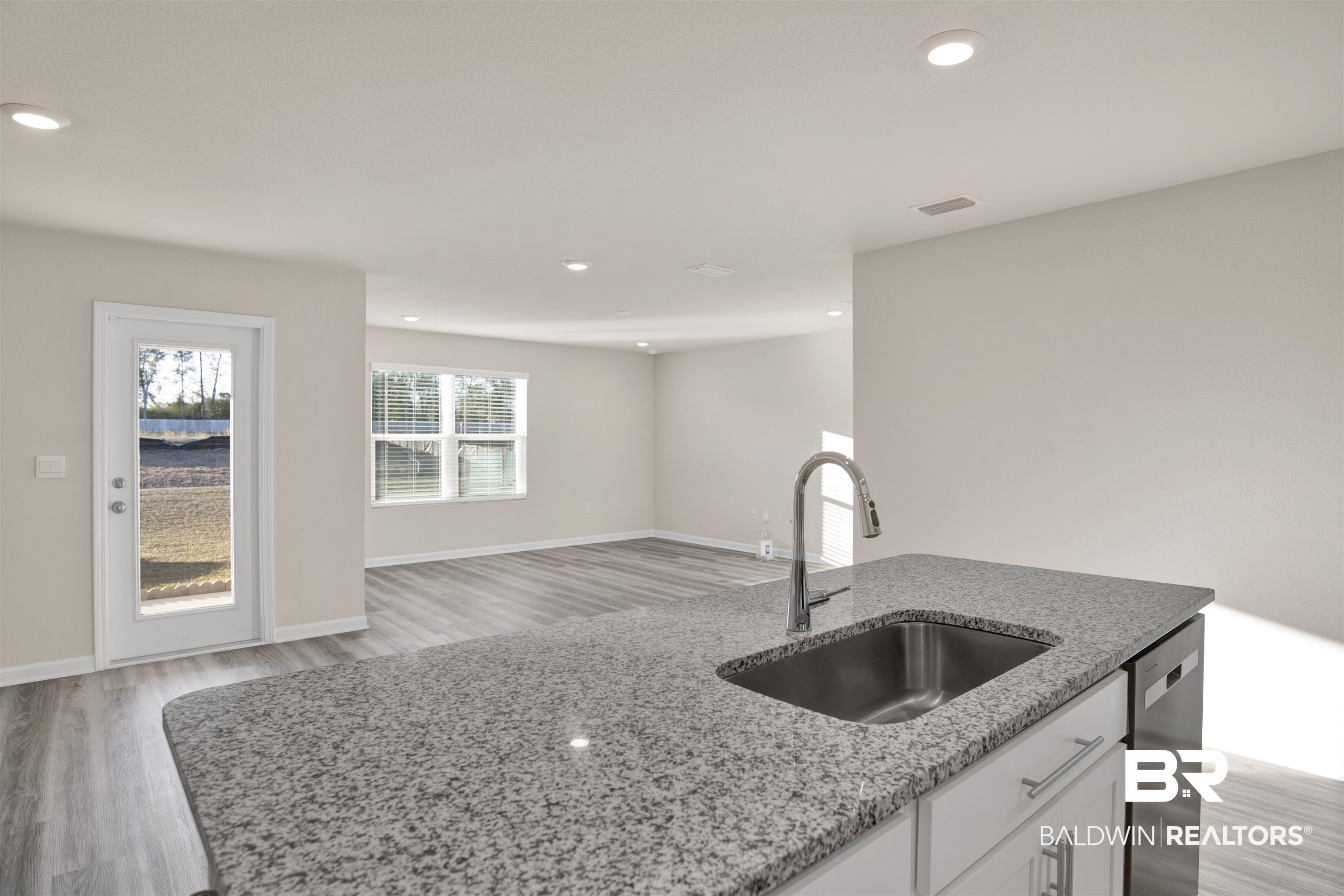 32038 Lyon Road Daphne, AL 36527 - Photo 7 of 30 Kitchen with white cabinets, light stone counters, light wood finished floors, recessed lighting, and dishwasher