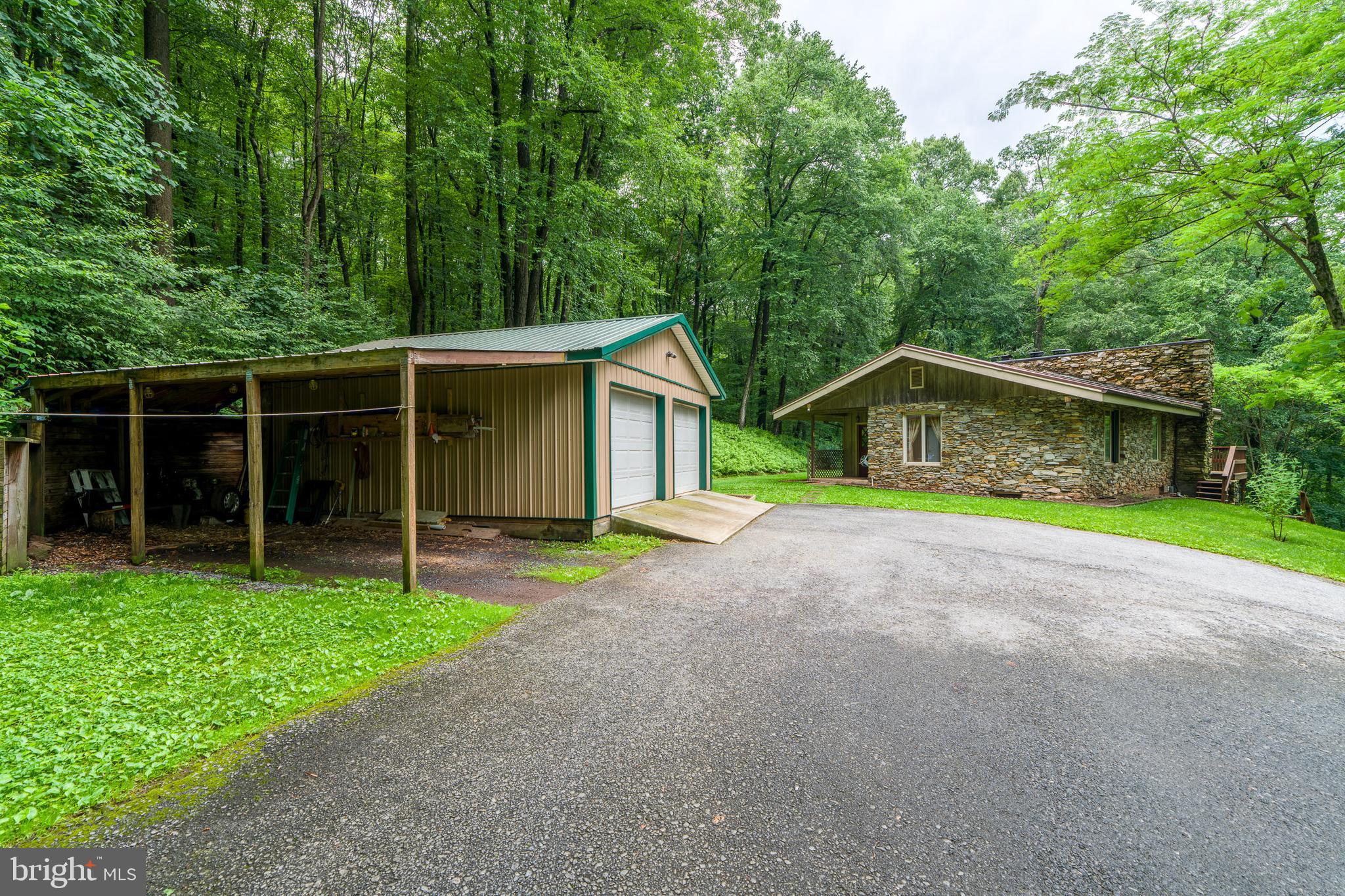 135 Fraelich Road Denver, PA 17517 - Photo 12 of 53 a yellow house with trees in front of it