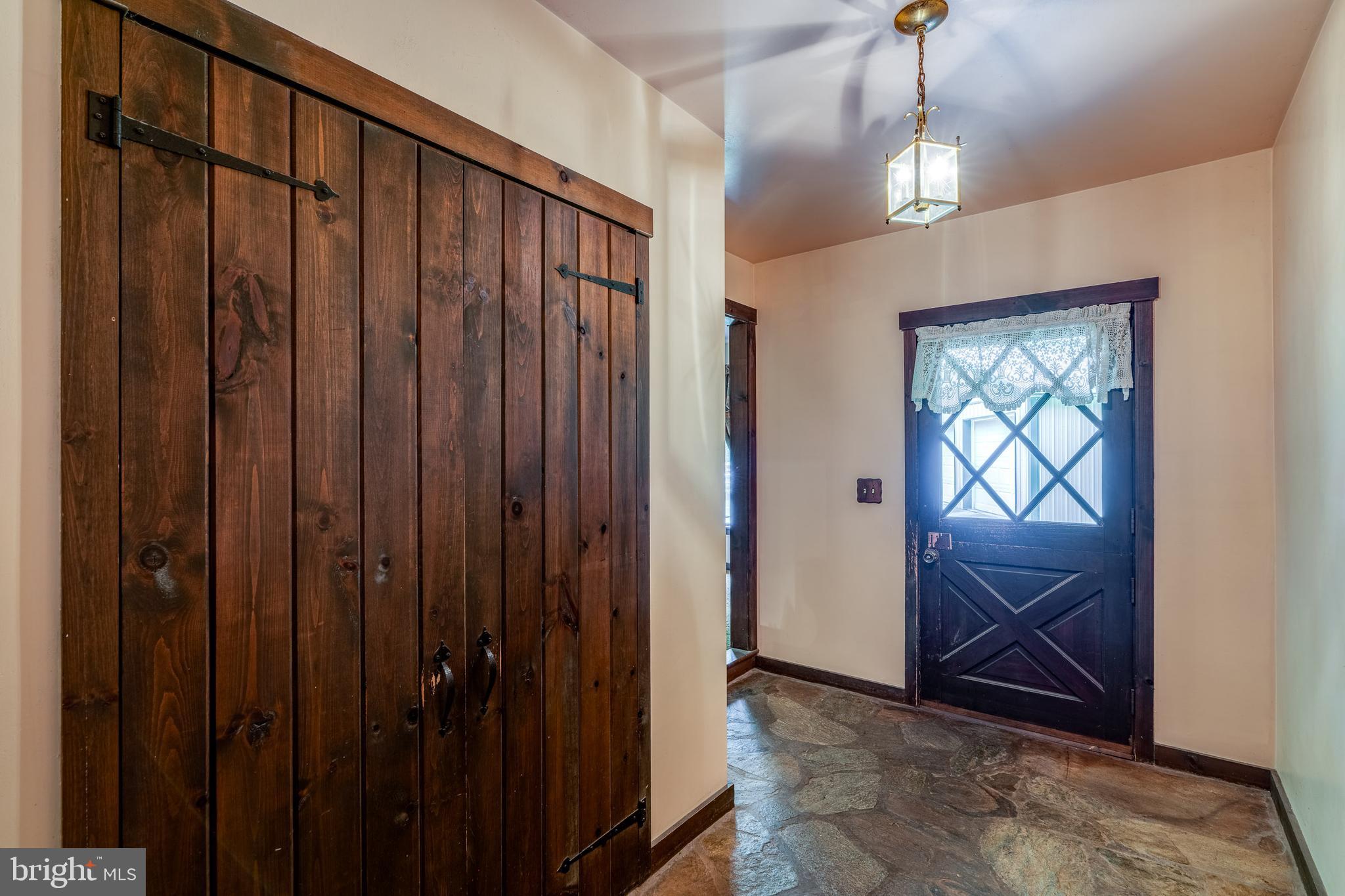 135 Fraelich Road Denver, PA 17517 - Photo 15 of 53 a view of a porch with wooden floor and stairs