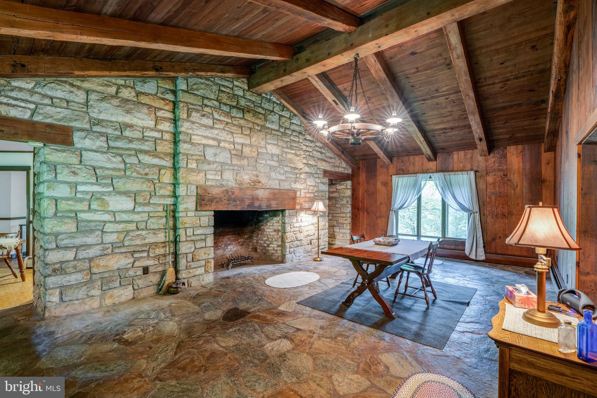 135 Fraelich Road Denver, PA 17517 - Photo 19 of 53 a view of a porch with furniture and a fireplace