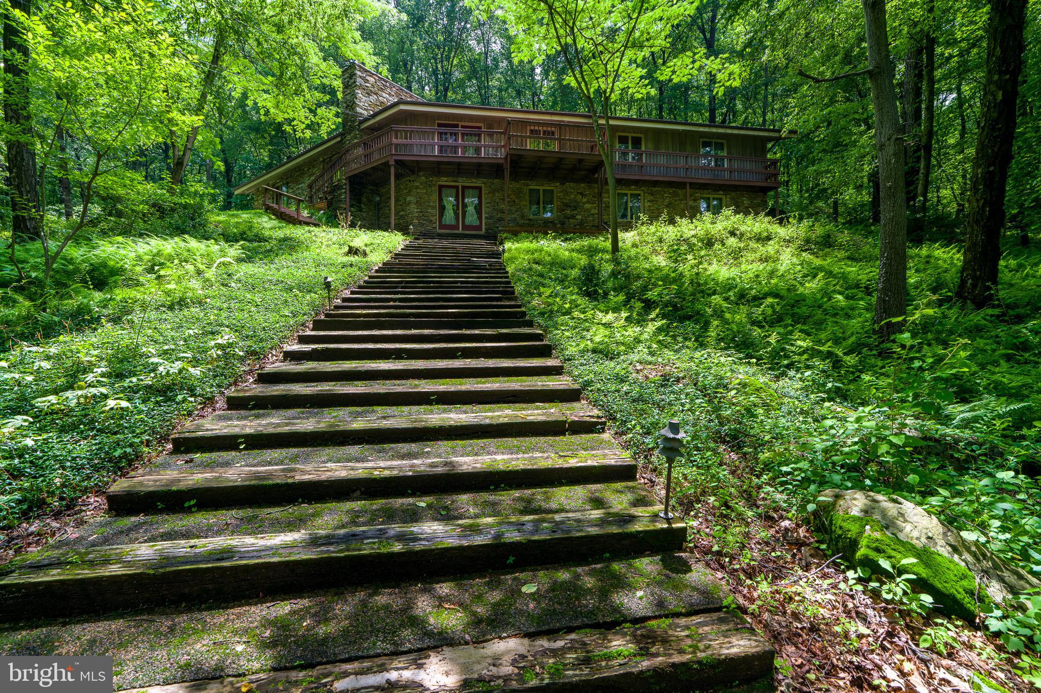 135 Fraelich Road Denver, PA 17517 - Photo 2 of 53 a view of a yard with wooden deck and a garden