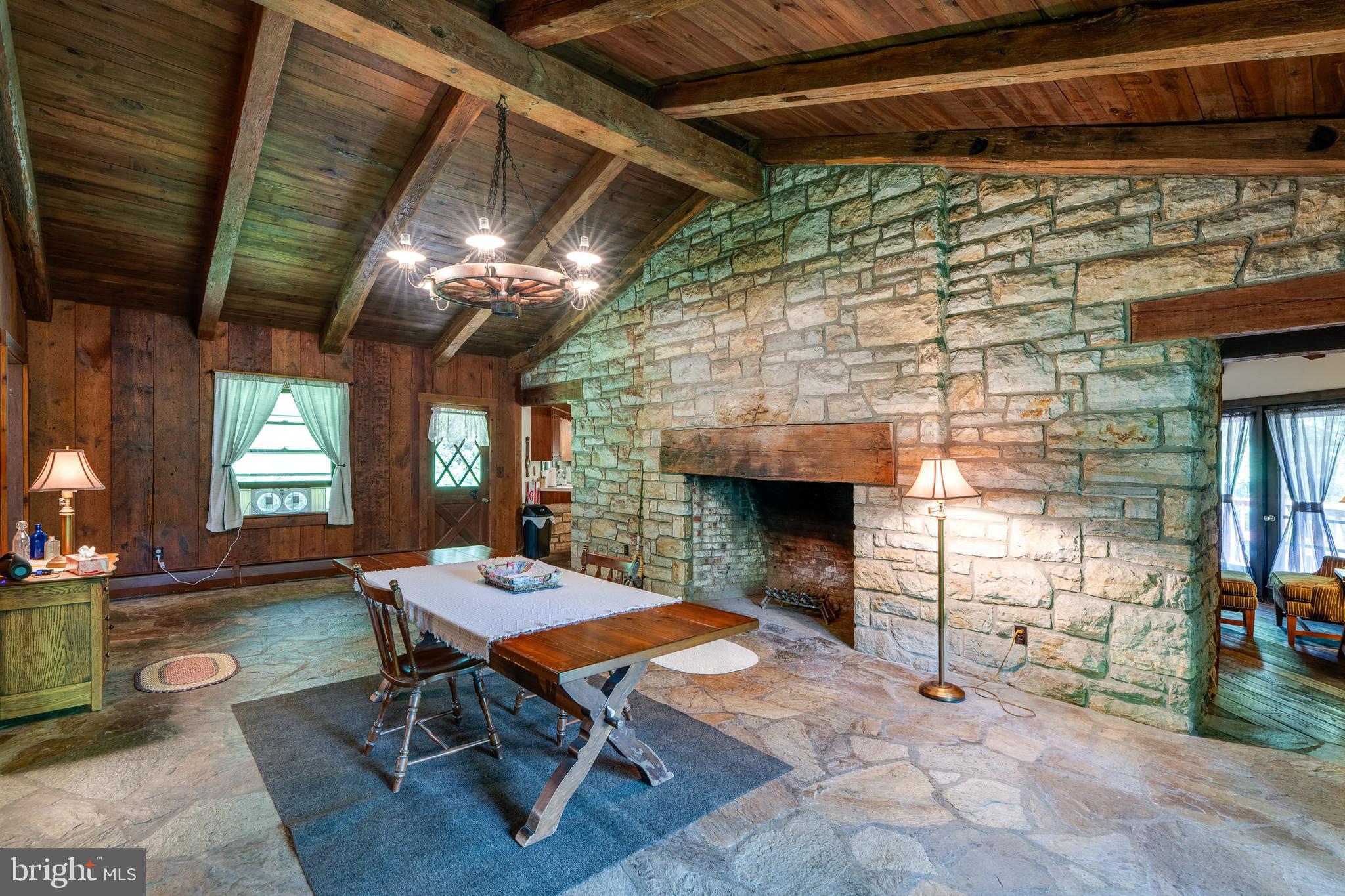 135 Fraelich Road Denver, PA 17517 - Photo 22 of 53 a living room with furniture a fireplace and a table