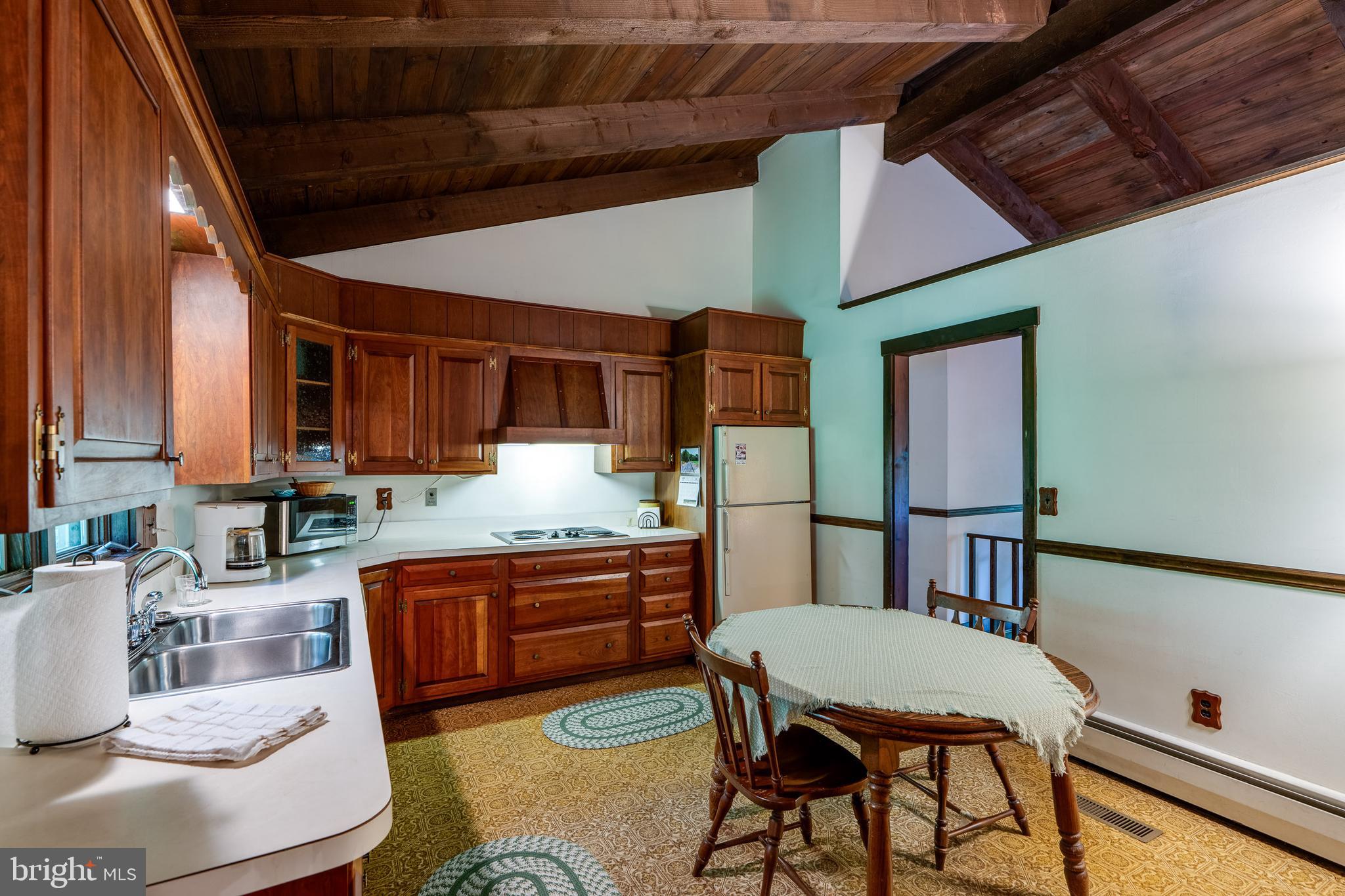 135 Fraelich Road Denver, PA 17517 - Photo 25 of 53 a kitchen with stainless steel appliances kitchen island granite countertop a table chairs and a refrigerator