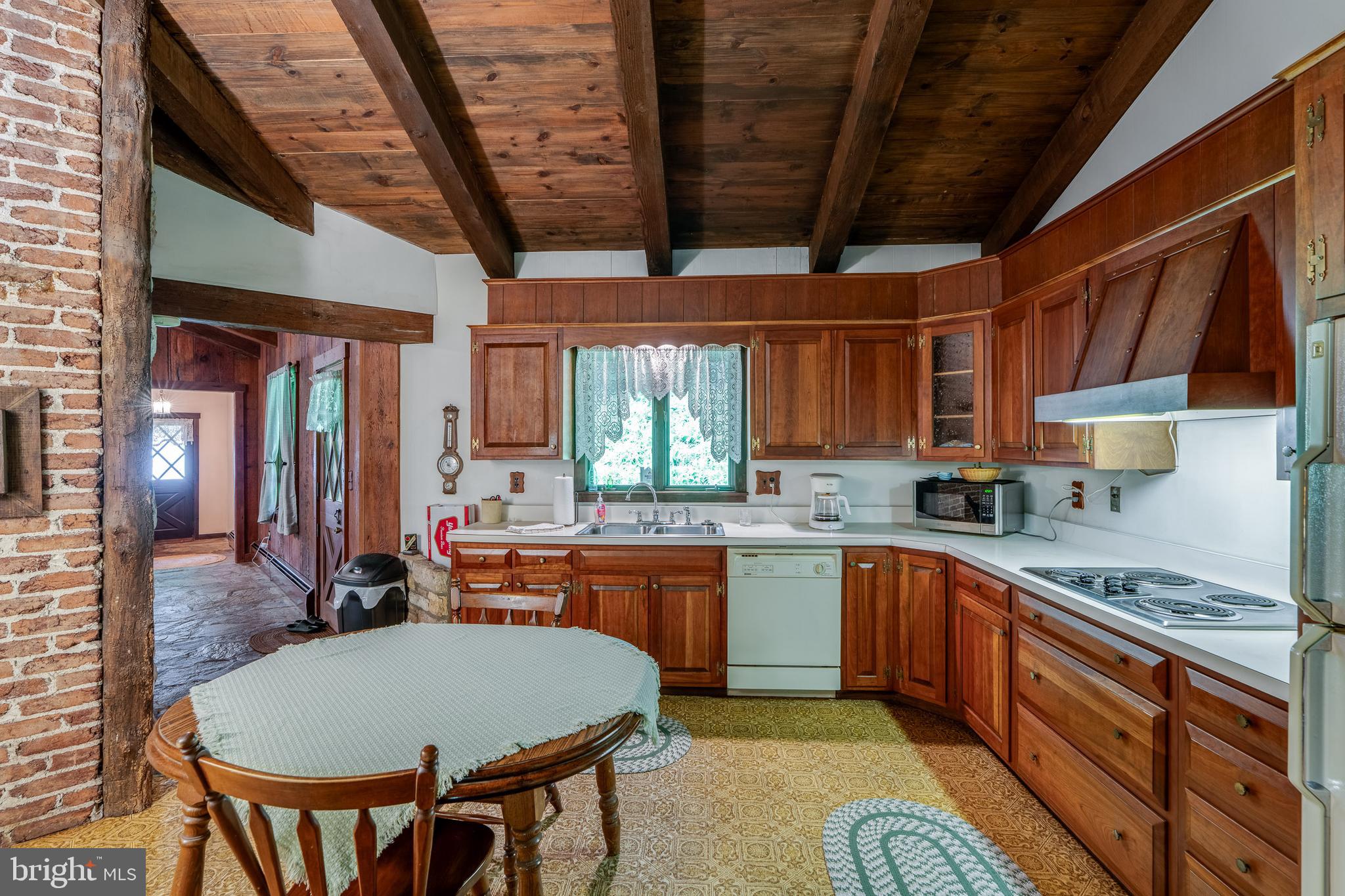 135 Fraelich Road Denver, PA 17517 - Photo 27 of 53 a kitchen with stainless steel appliances granite countertop a stove a sink dishwasher and cabinets with wooden floor