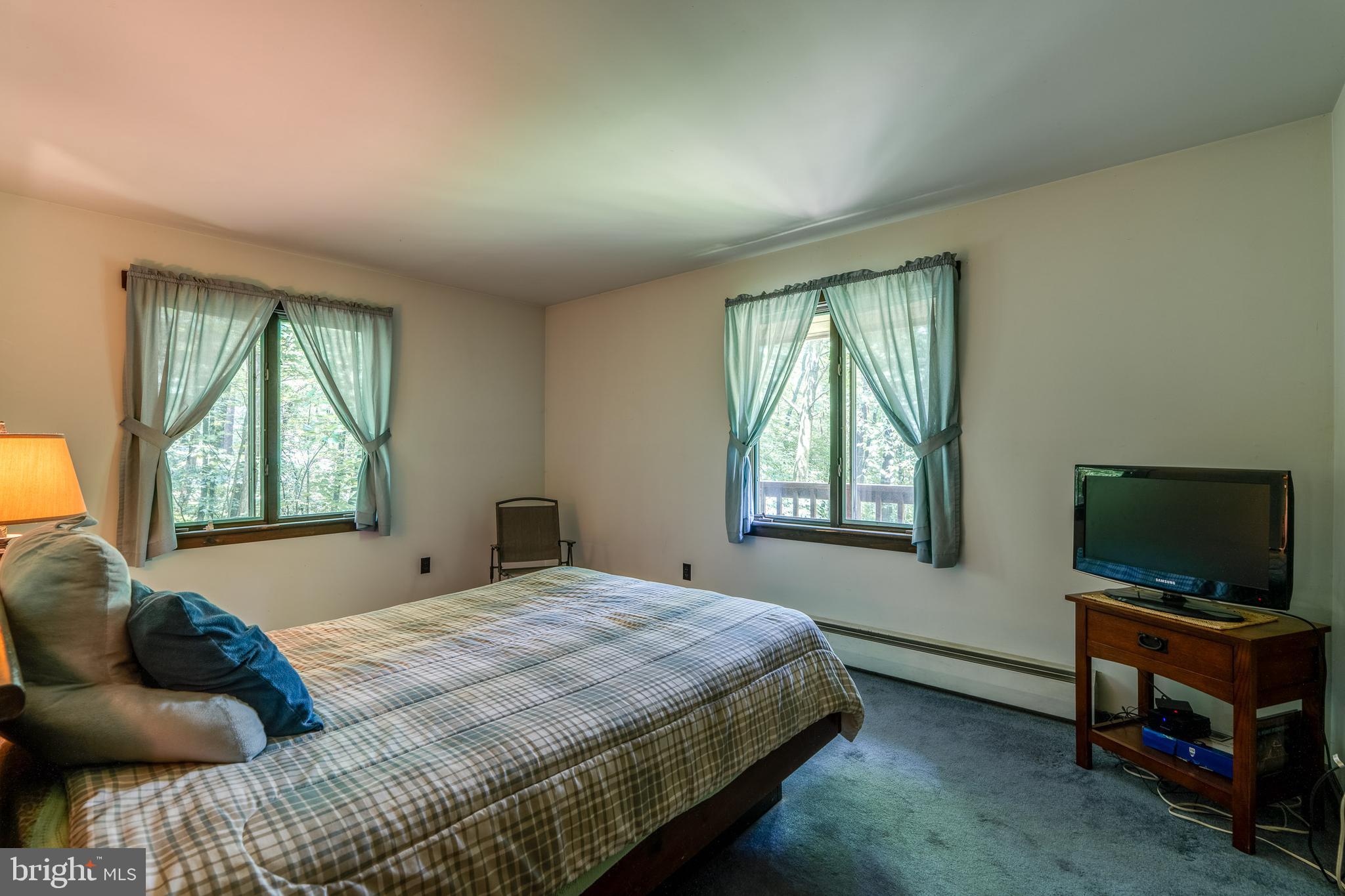 135 Fraelich Road Denver, PA 17517 - Photo 35 of 53 a bedroom with a bed and flat screen tv