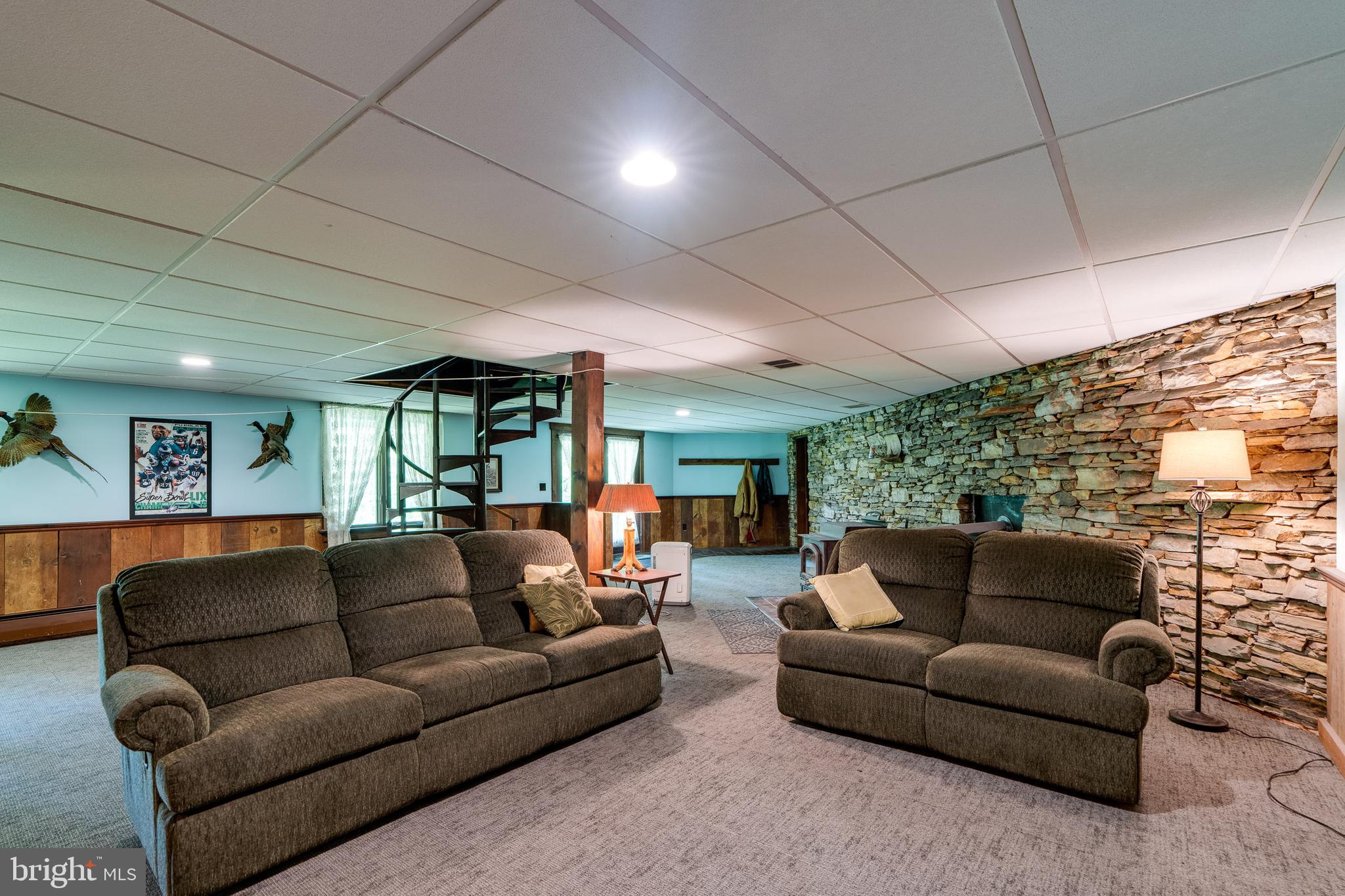 135 Fraelich Road Denver, PA 17517 - Photo 45 of 53 a living room with furniture a large window and a projector