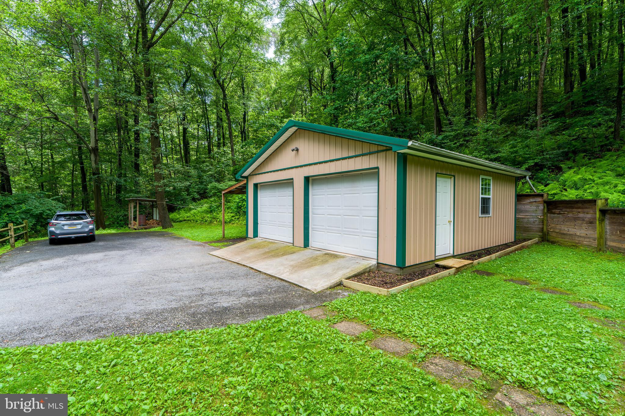 135 Fraelich Road Denver, PA 17517 - Photo 10 of 53 a front view of a house with a yard and garage