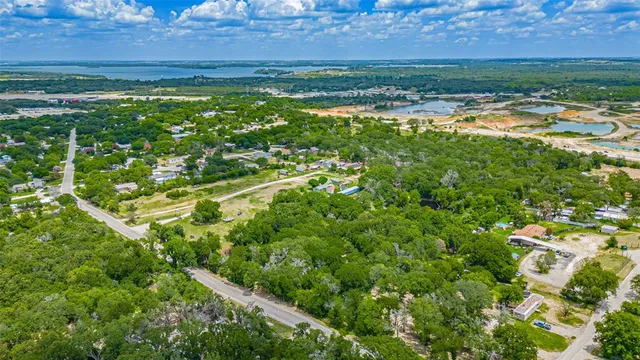 an aerial view of residential houses with outdoor space and river