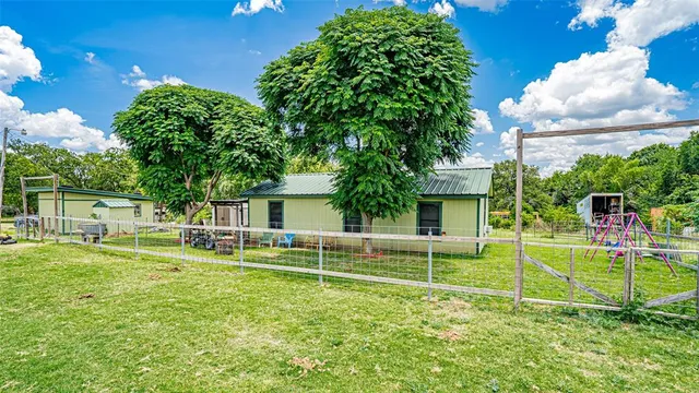 a view of a house with swimming pool and a yard