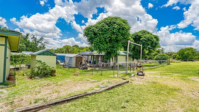 a yellow house with trees in front of it
