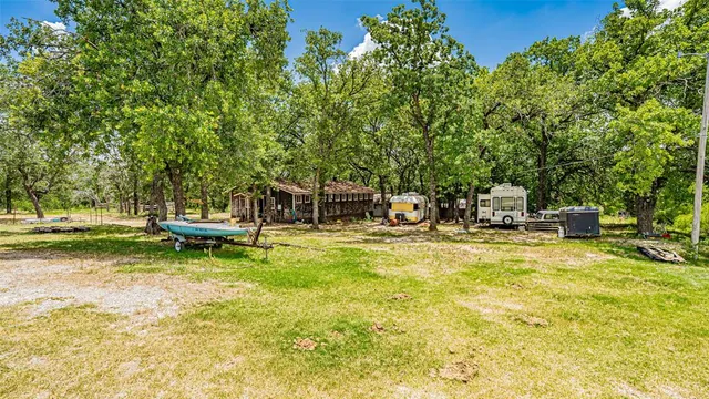 a view of a house with a chairs and table in a patio